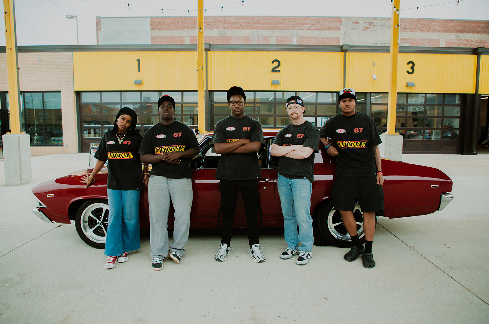 Students from Operation Breakthrough’s Ignition Lab — Maliyah Monroe, Suleyman Dia, Jeremiyah Bradley, Chapman Campbell (instructor), and  Josiah Bryant — pose in streetwear they designed with MADE MOBB at the Troost Avenue educational site; photo courtesy of MADE MOBB