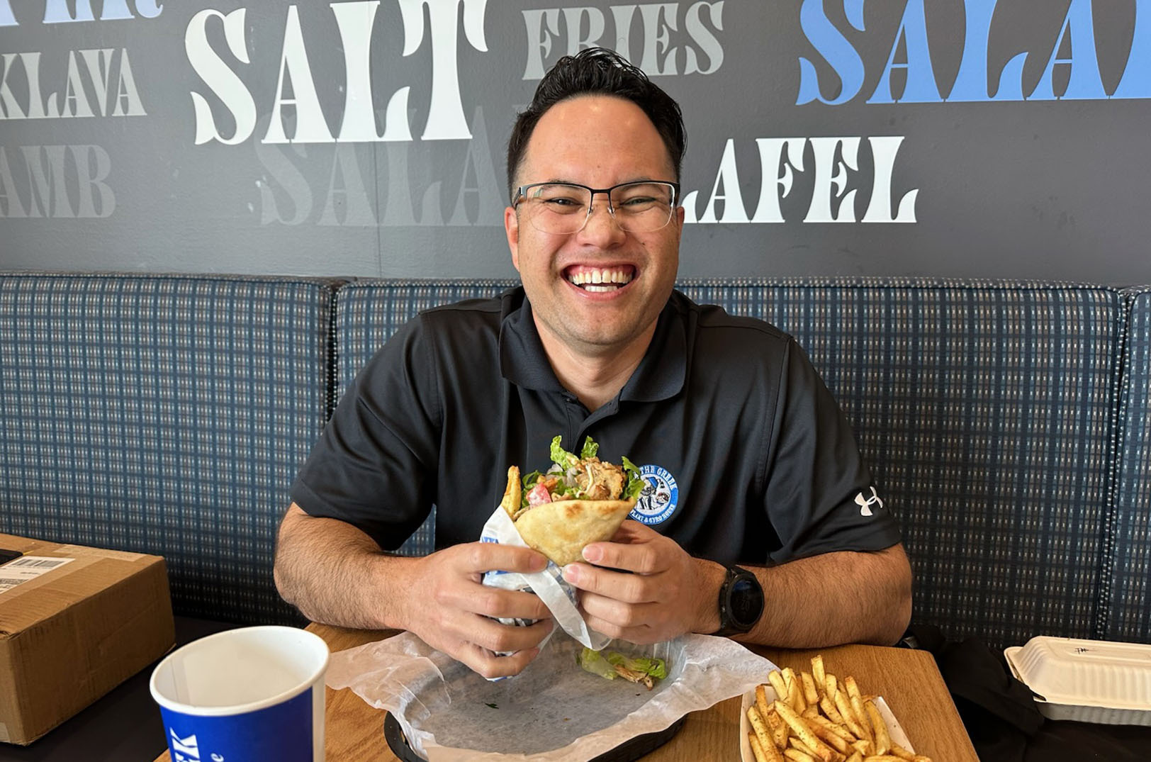 Arthur Gilbreath eating Nick The Greek for the first time since November 2024 during a training session at the Ward Parkway location; photo by Joyce Smith