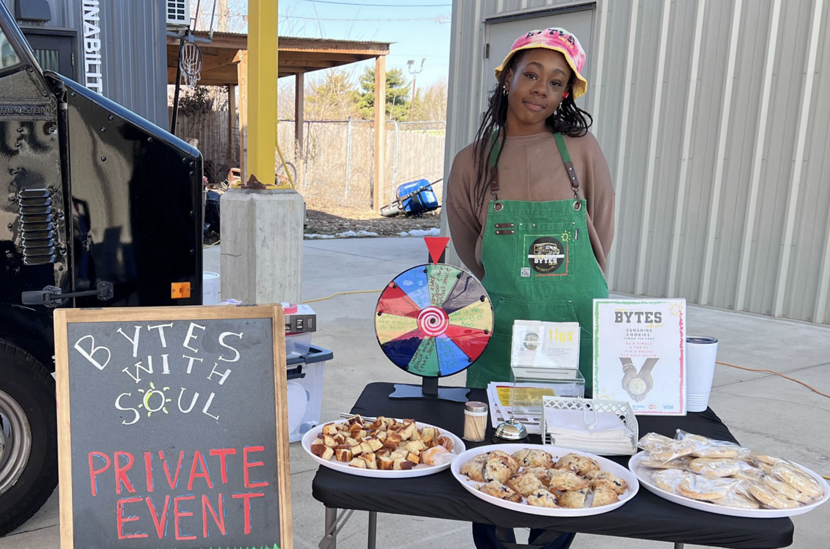 A teenage participant in Operation Breakthrough programming works outside the youth entrepreneurship-focused Bytes with Soul food truck; photo courtesy of Operation Breakthrough