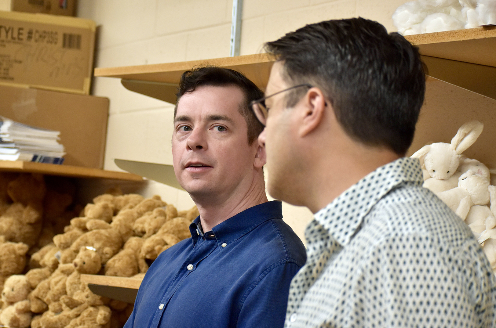 Brett Goodwin and Alan Tipton, owners of The Learning Tree, discuss the impact of tariffs on their Prairie Village store with U.S. Rep. Sharice Davids, D-Kansas; photo by Nikki Overfelt Chifalu, Startland News