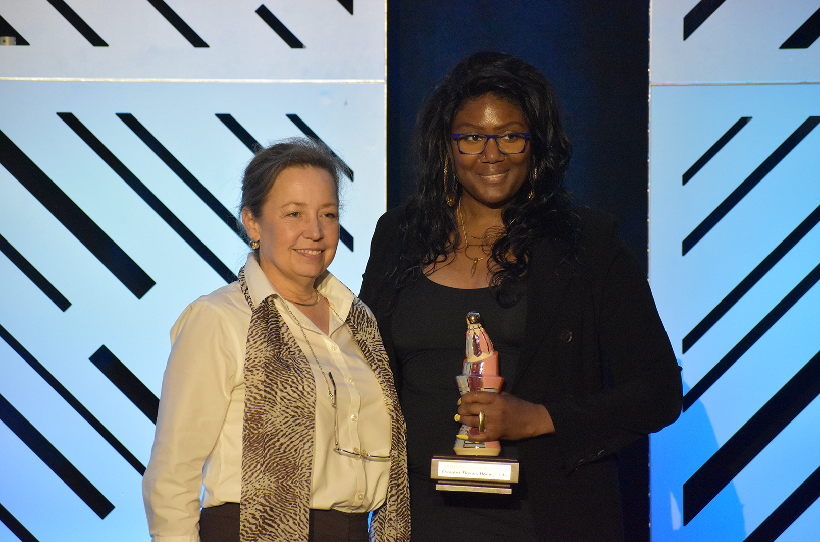 Dana Knapp, president and CEO of ArtsKC, presents Keisha Jordan, founder of Complex Flavors Home + Life, with the KC Chamber's 2025 Luminary Arts & Creative Small Business Award; photo by Taylor Wilmore, Startland News
