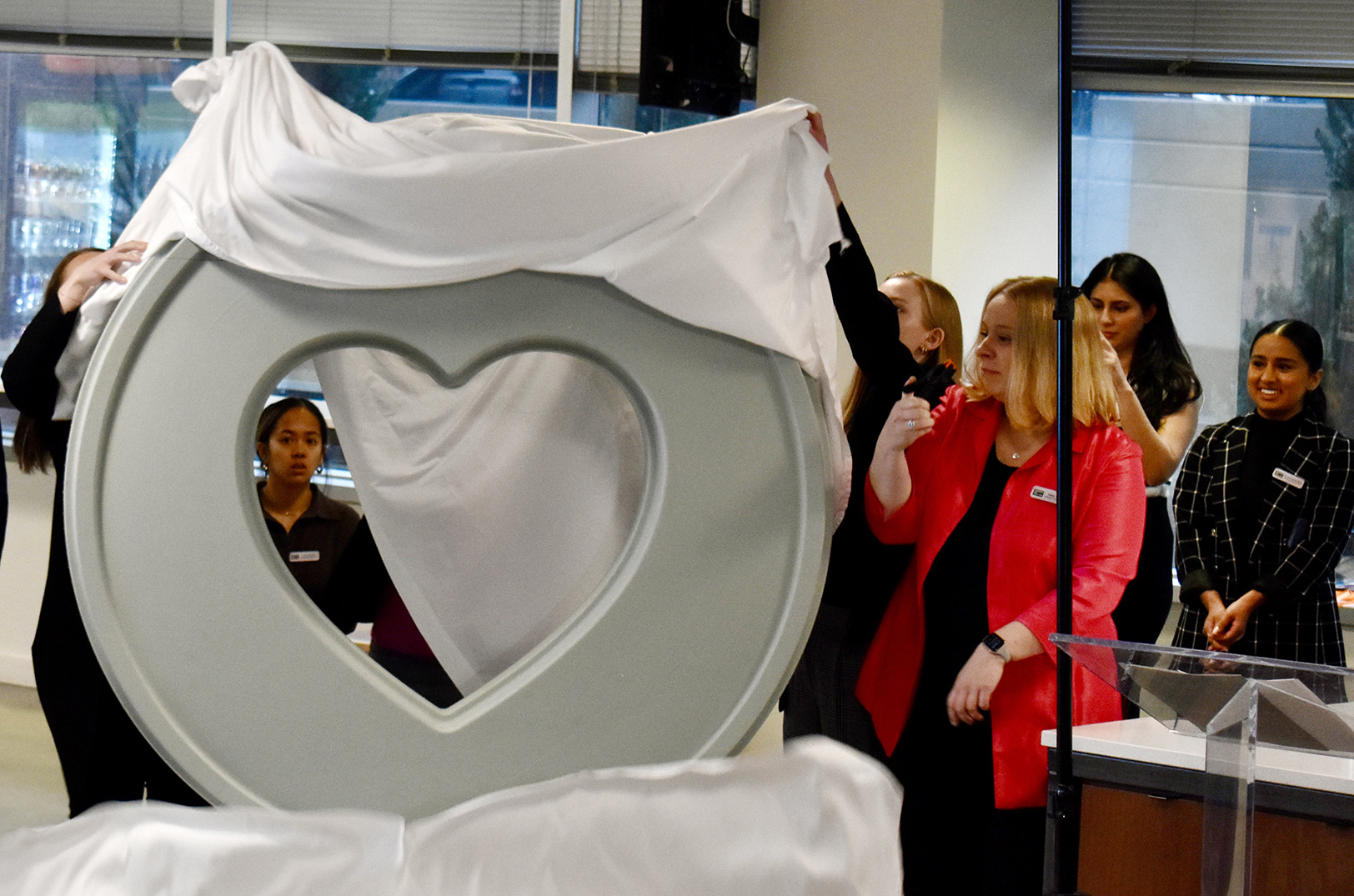 Community leaders unveil the 2026 sculpture design for Parade of Hearts in March at nbkc bank; photo by Nikki Overfelt Chifalu, Startland News