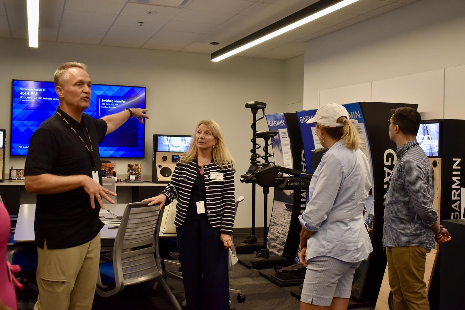 Scott Burgett, senior director of Garmin Health Engineering, leads visitors like Jill Meyer, UMKC Innovation Center, Darcy Howe, KCRise Fund, and Thomas Papadatos, eGrowth Ventures, on a tour of Garmin tech during a Digital Health Day event; photo by Nikki Overfelt Chifalu, Startland News