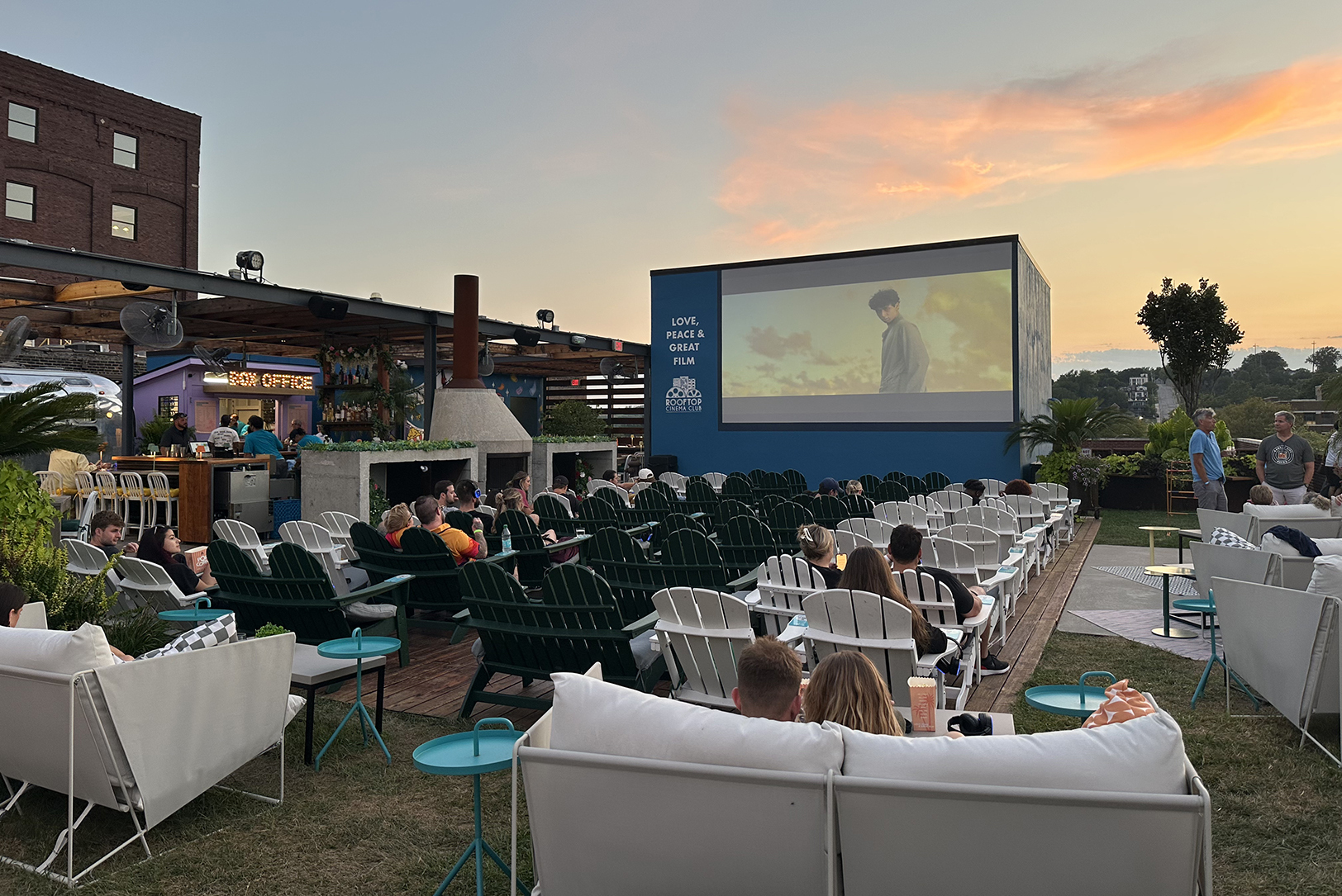 The glow of the Kansas horizon provides a backdrop for scenes at Rooftop Cinema Club in Kansas City; photo by Joyce Smith