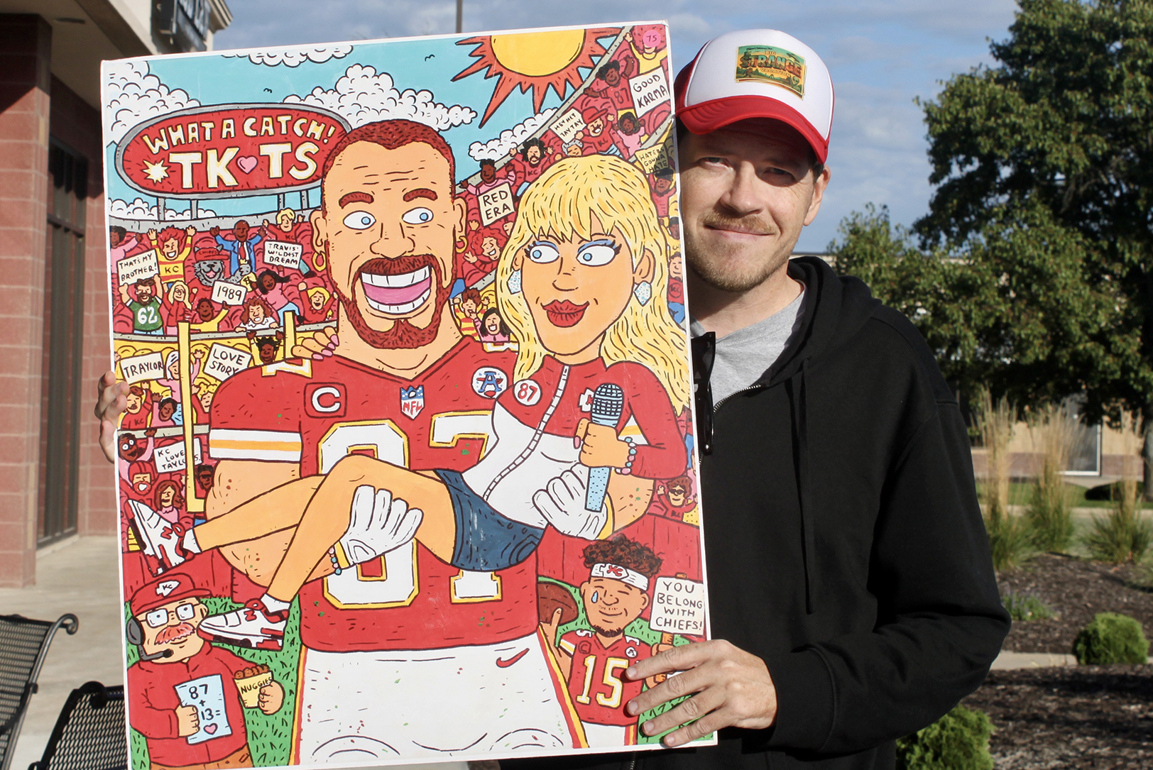 W. Dave Keith holds his "What a Catch" painting; photo by Nikki Overfelt Chifalu, Startland News