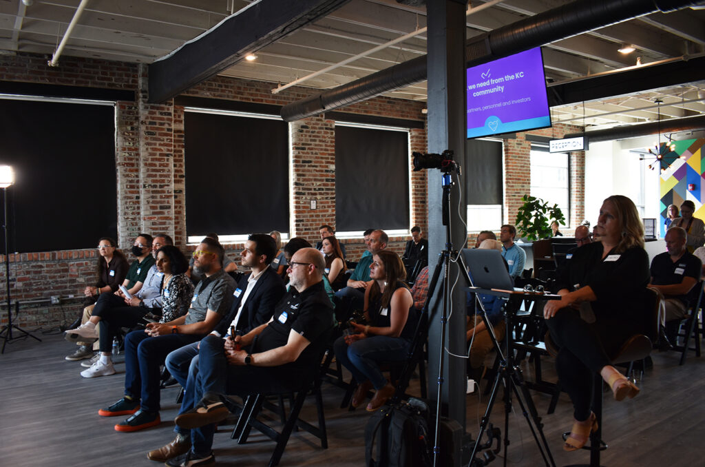 Fellows, guests and members of the public watch pitches at the Futures Group during the Comeback KC Ventures Innovation Showcase